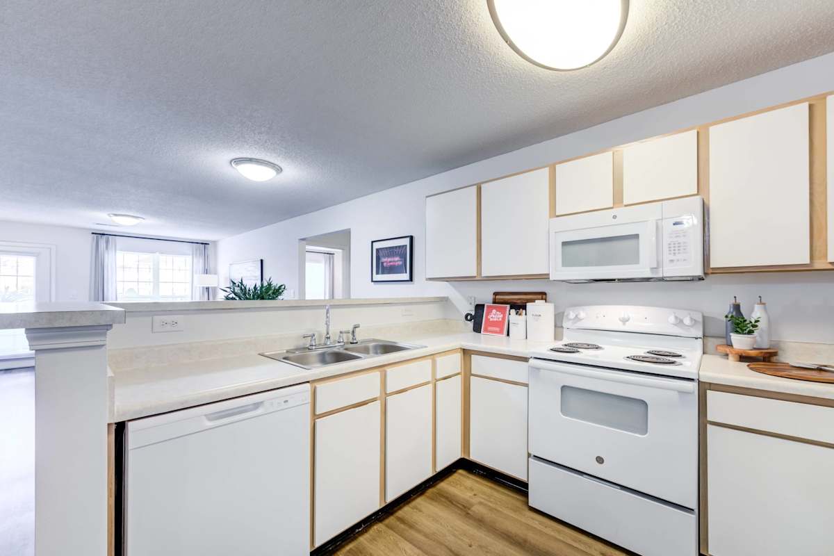 Legacy at Cross Creek kitchen with stove and cabinets - Fayetteville, NC