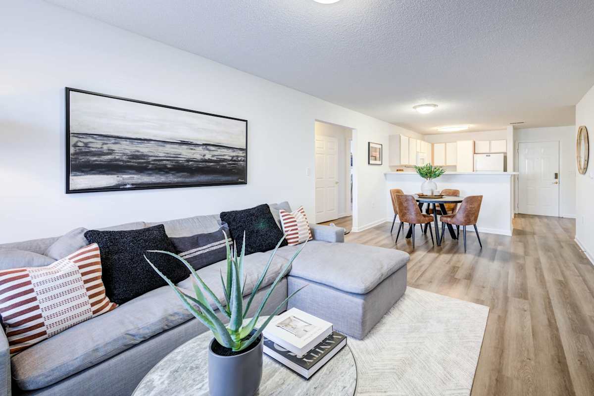 Legacy at Cross Creek living room with sofa and wall art - Fayetteville, NC