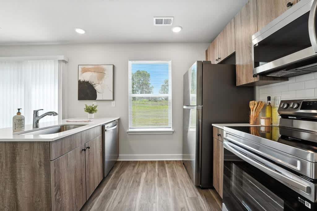 Rustic Heights Townhomes stainless steel kitchen appliances - Oak Grove, MO