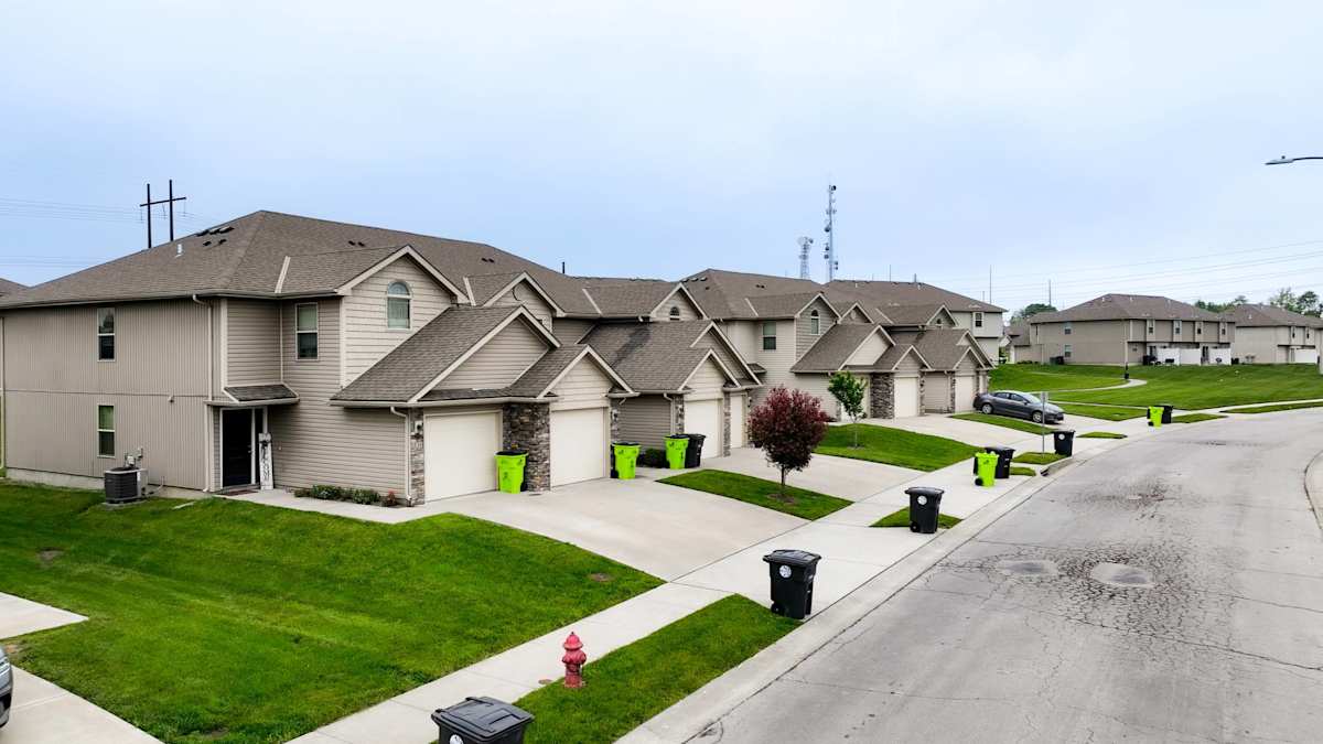 Traditions Townhomes exterior street view of townhome row - Belton, MO