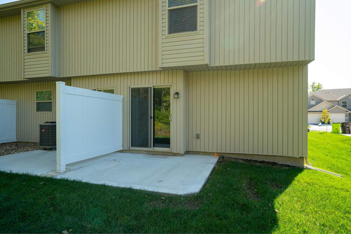 Traditions Townhomes exterior with garage door - Belton, MO