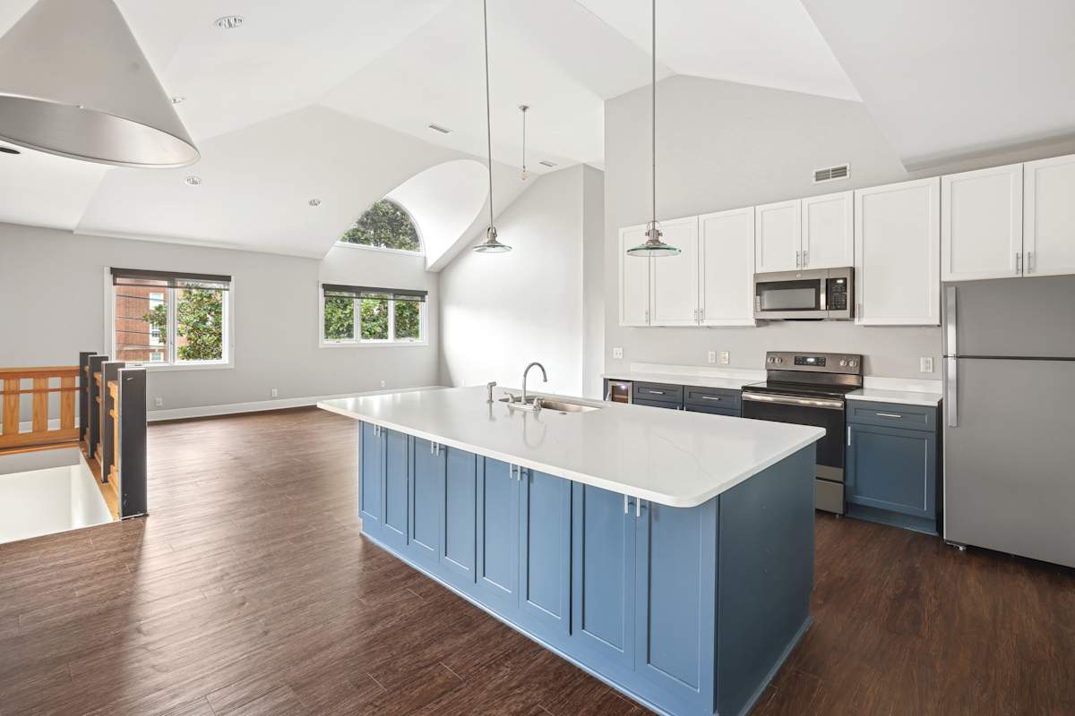 Midtown Square Apartments kitchen with blue cabinets and white counters - Nashville, TN