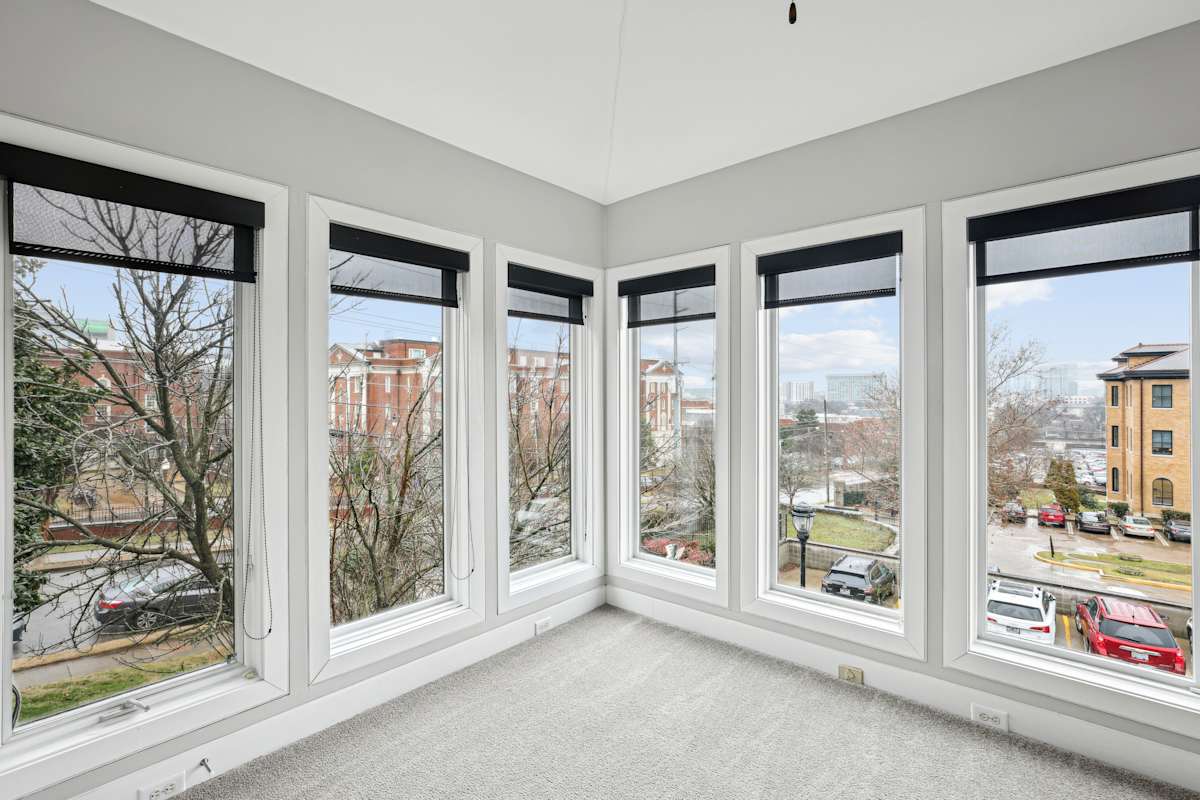Midtown Square Apartments room with large windows overlooking street - Nashville, TN