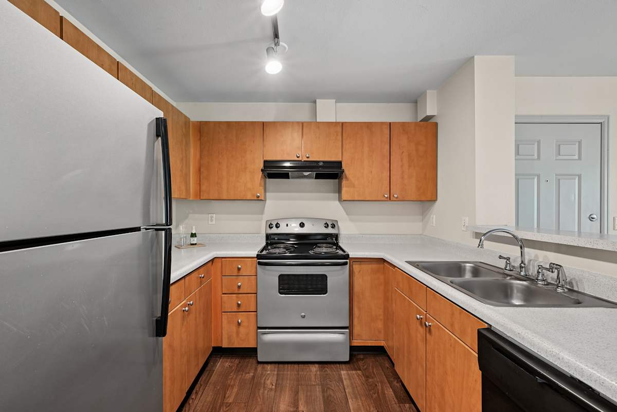 Ardenne Apartments kitchen with stainless refrigerator - Lafayette, CO
