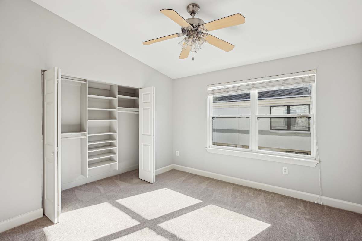 Wesley Place Apartments room with window, ceiling fan, and rug - Nashville, TN
