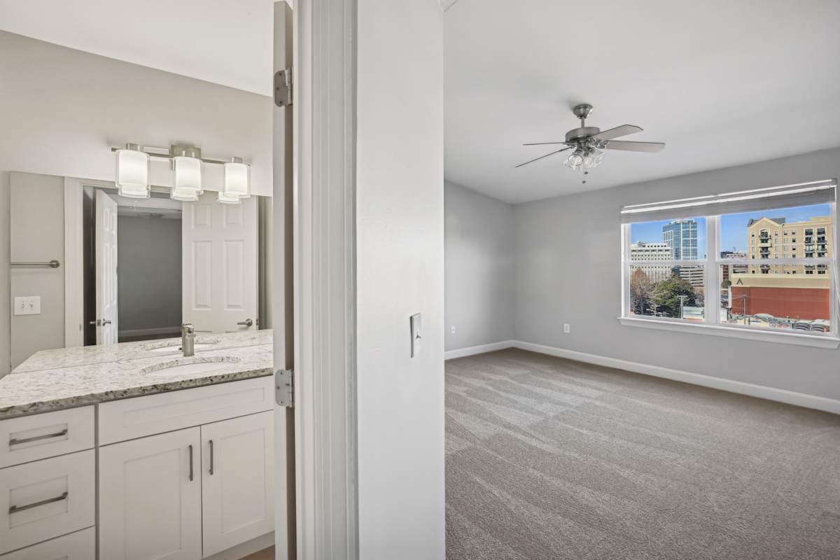 Wesley Place Apartments empty room with ceiling fan and city view - Nashville, TN