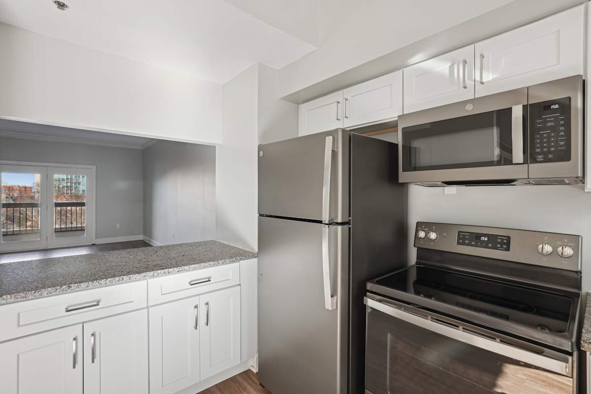 Wesley Place Apartments kitchen with stainless steel refrigerator and oven - Nashville, TN