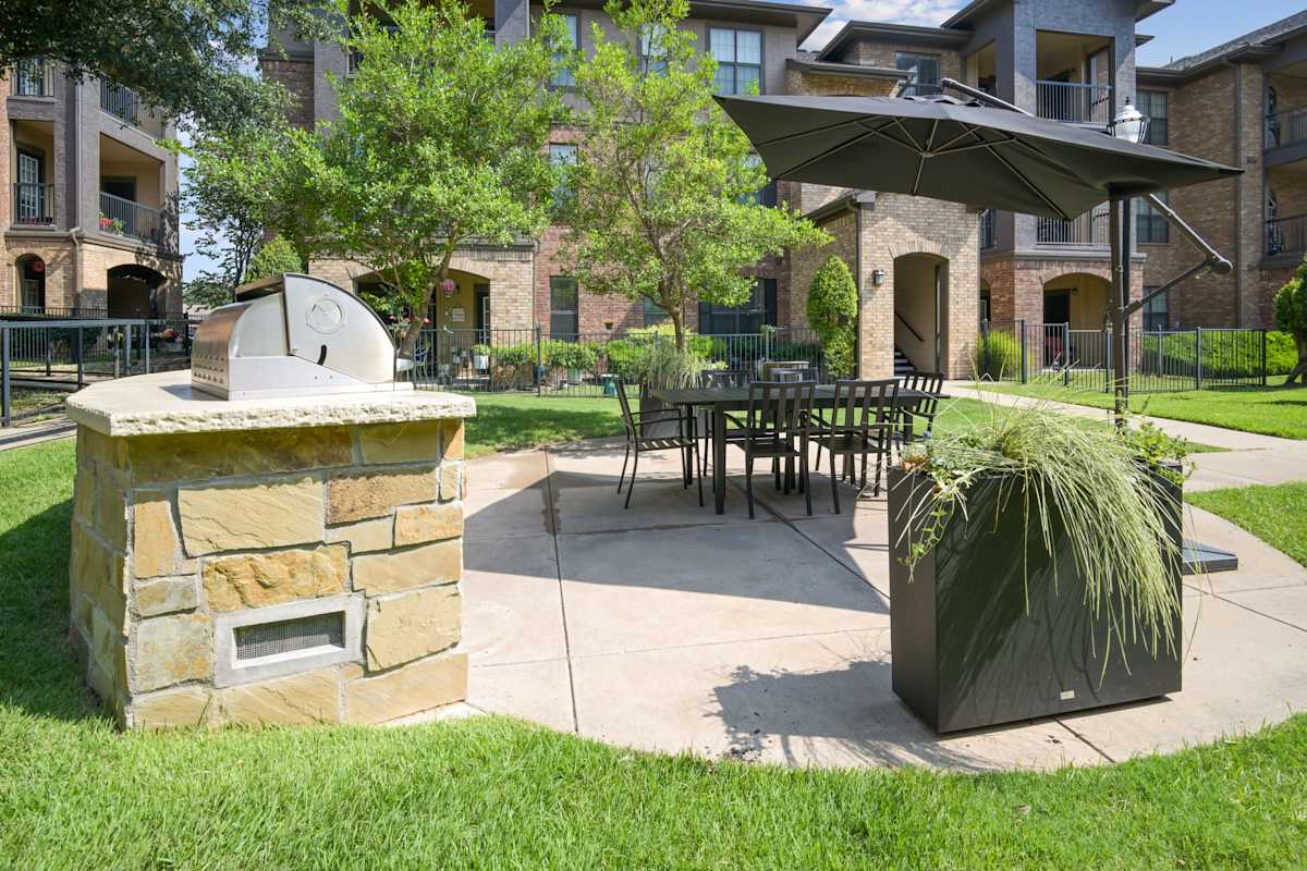 Greenhaven Apartments outdoor patio with fireplace and seating - McKinney, TX