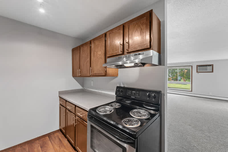Grand Pre East kitchen with stove and wood cabinets - Little Canada, MN