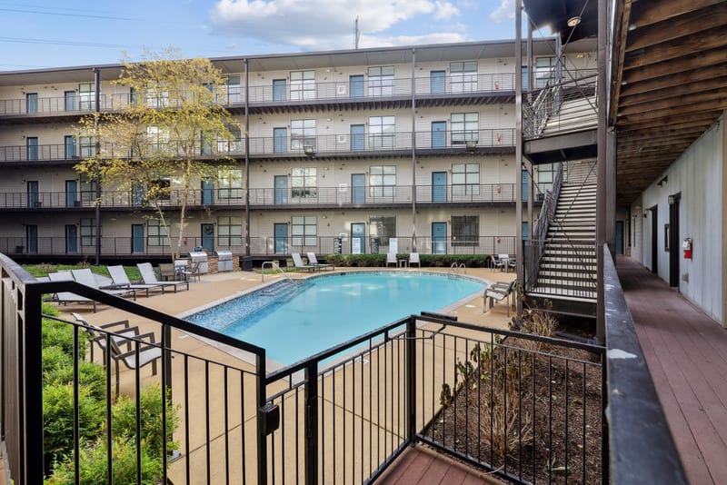 Gale Lofts pool courtyard with lounge chairs and buildings - Nashville, TN