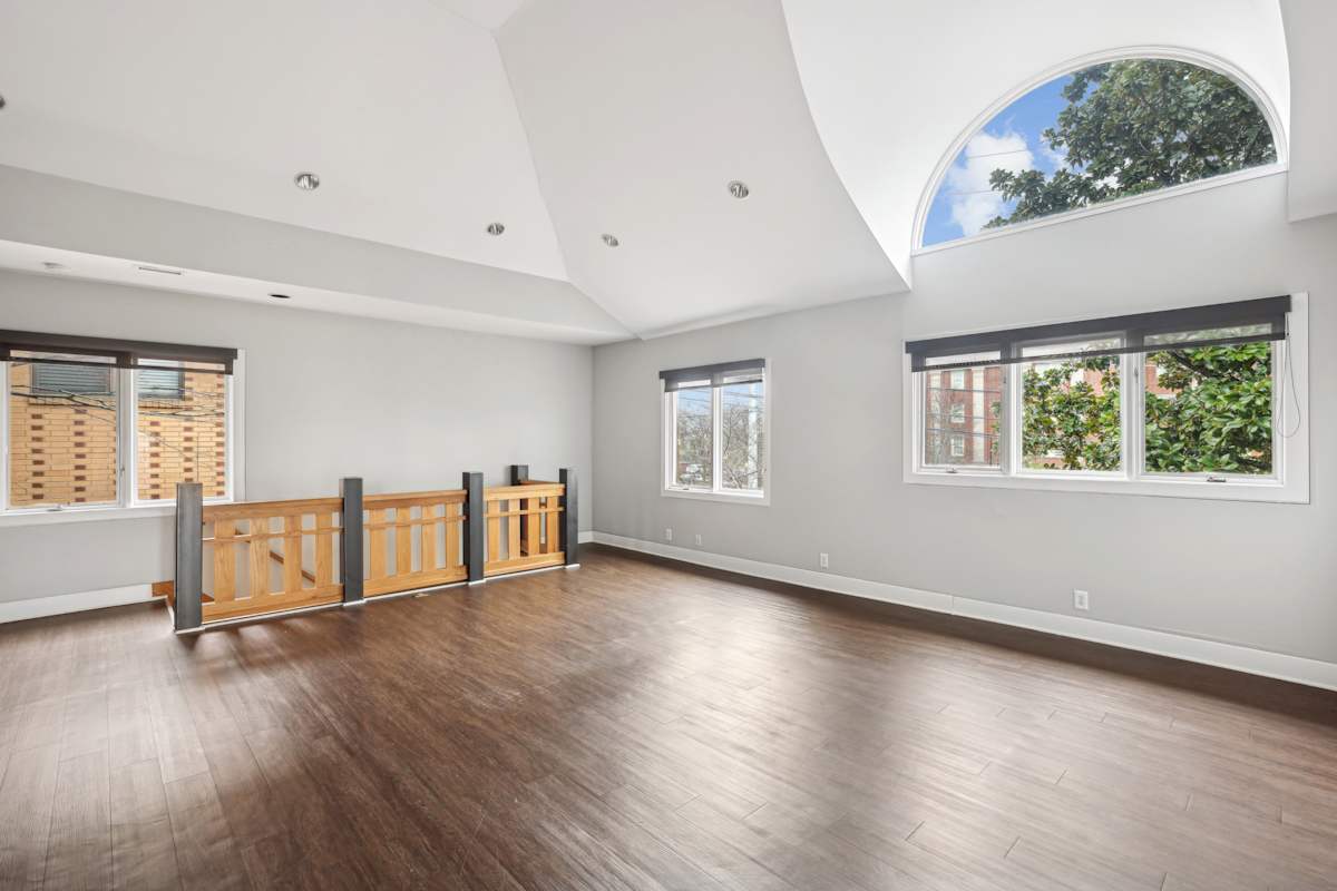 Midtown Square Apartments room with arched window and hardwood floors - Nashville, TN