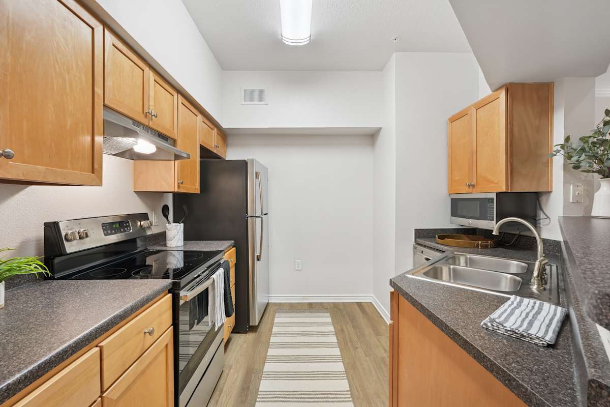 Inman Park kitchen with wood cabinets and black appliances - Raleigh, NC