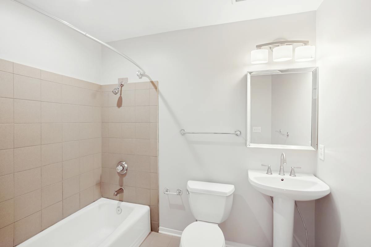Midtown Square Apartments bathroom with tub and vanity - Nashville, TN