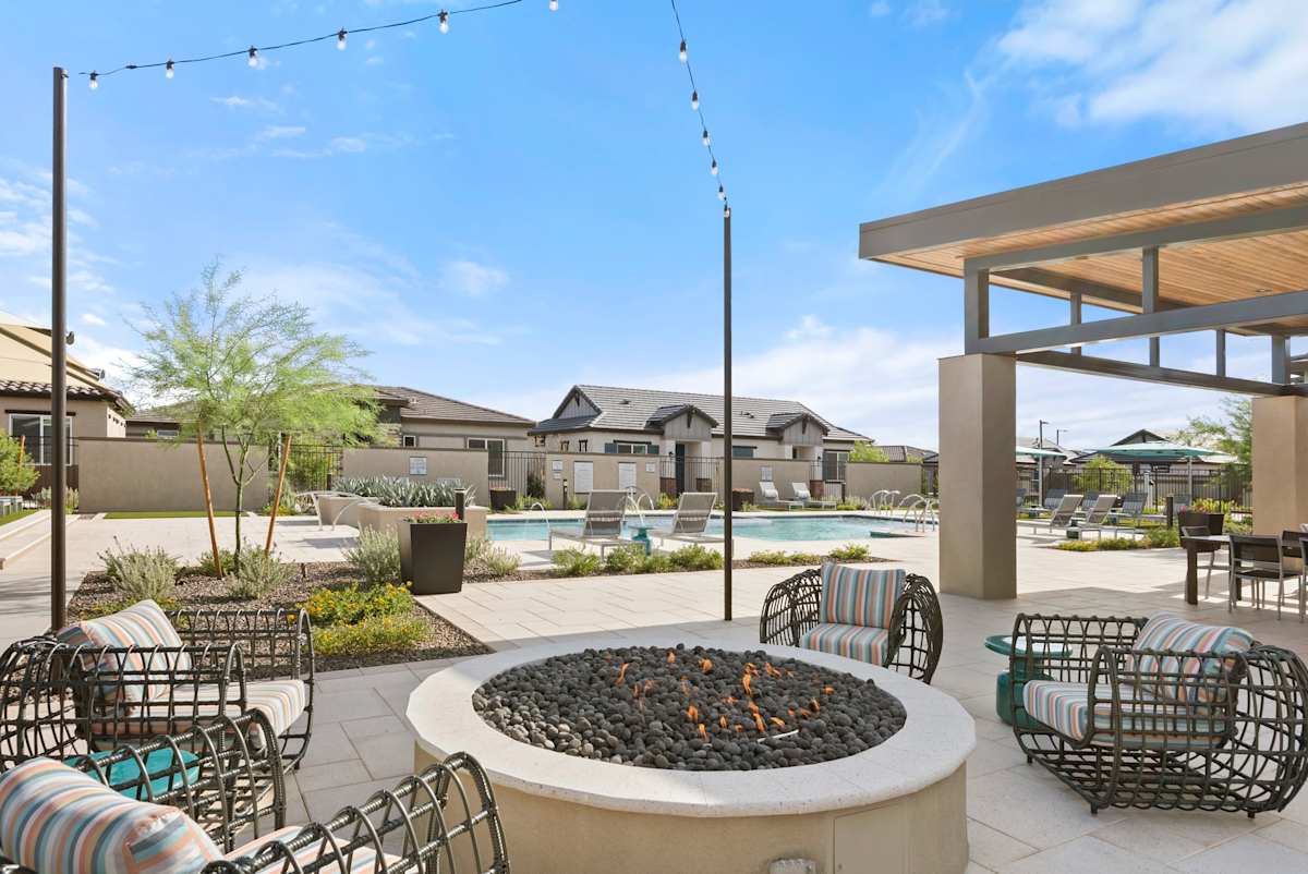 Fire-pit seating with outdoor string lights at Avilla Vista Norte.