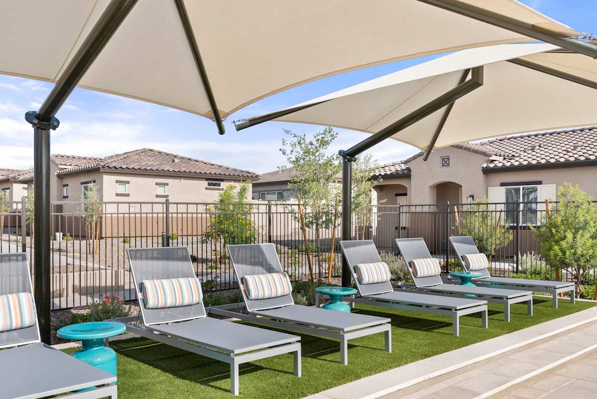 Shaded outdoor loungers on a turf area at Avilla Vista Norte.