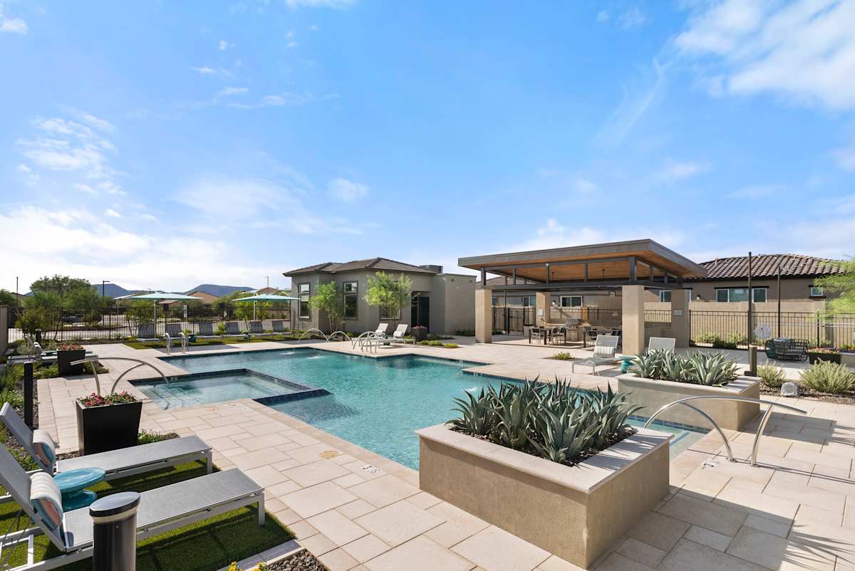Pool deck with sun loungers and landscaping at Avilla Vista Norte.