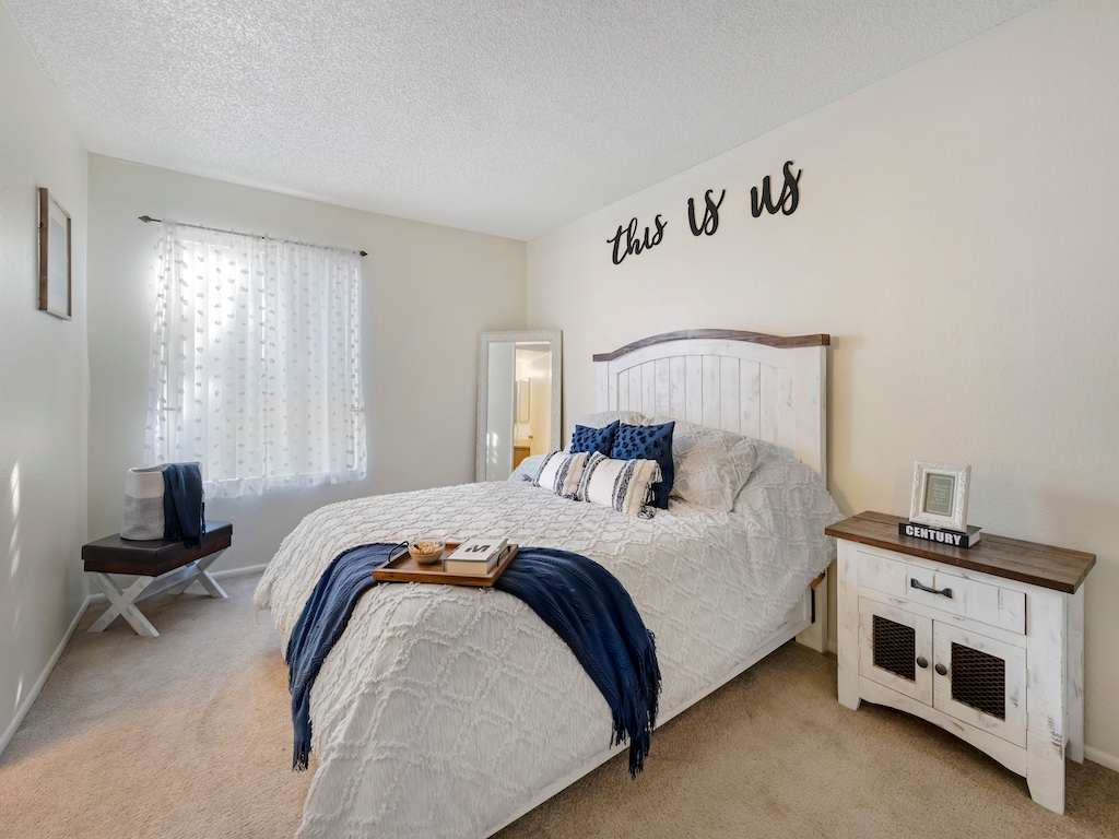 Furnished bedroom with window and closet storage — view 1 at Glen Oaks Apartments.