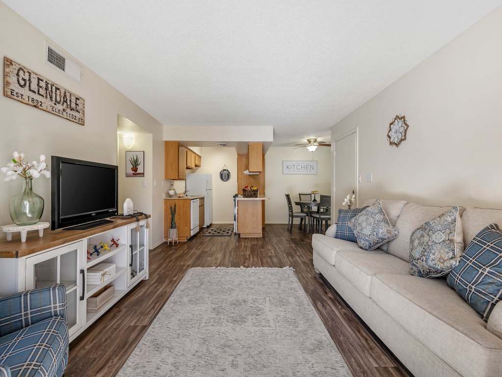 Furnished living room adjoining the kitchen — view 1 at Glen Oaks Apartments.