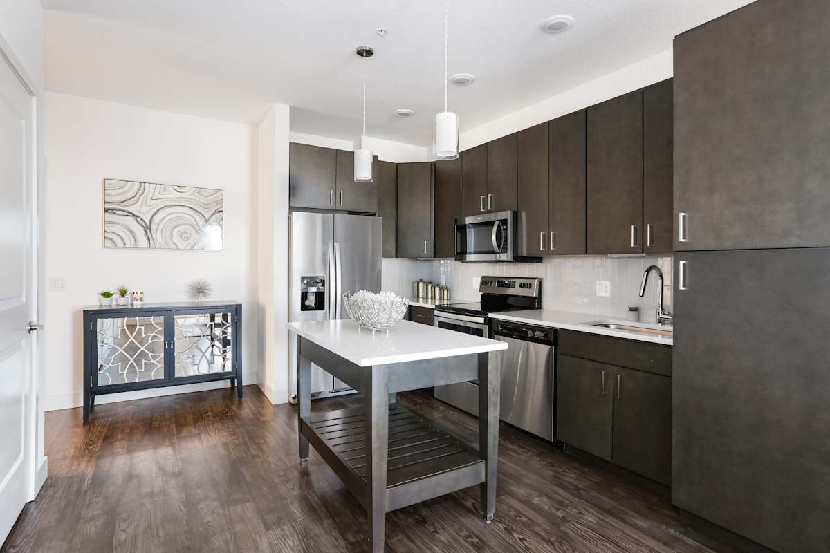 The Lydian kitchen with stainless steel appliances and island - Denver, CO