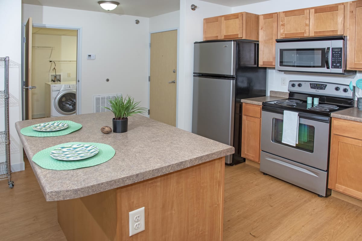 Ashland Apartment Homes kitchen with stainless steel appliances and island - Grand Forks, ND