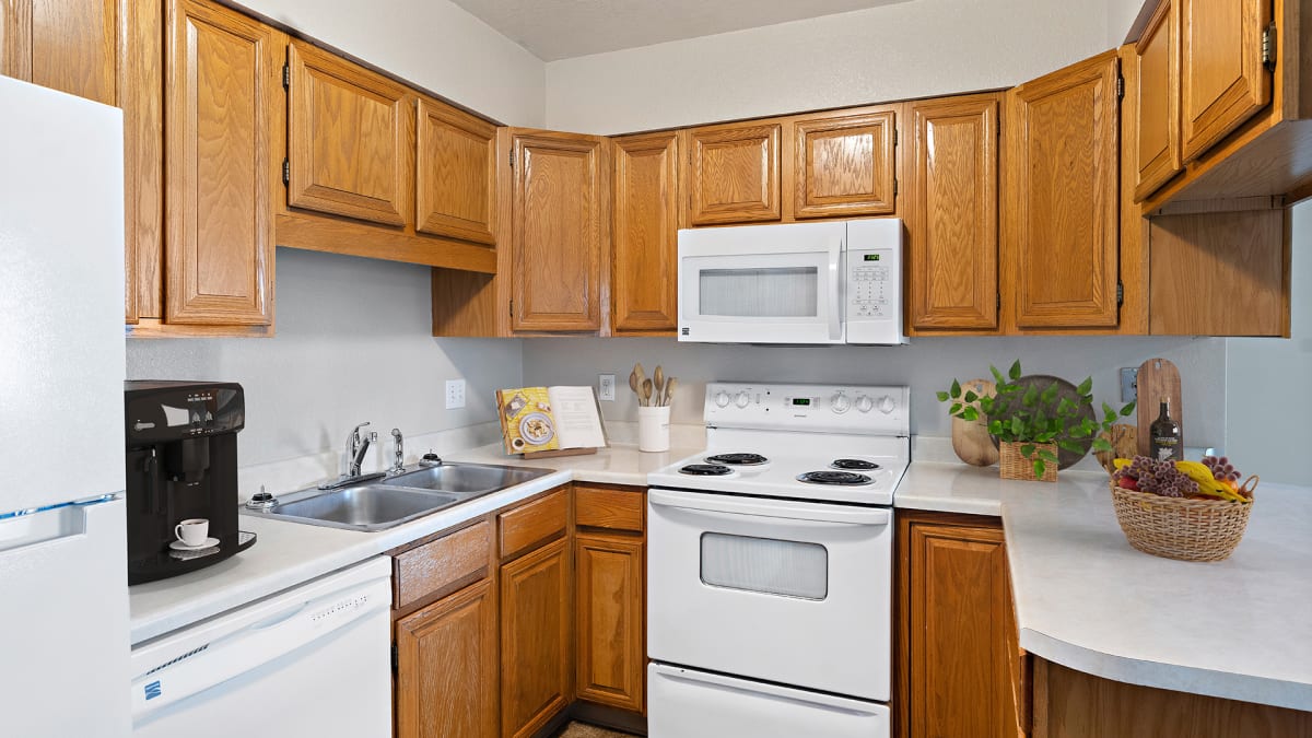 Castlerock Apartment Homes kitchen with white appliances - Billings, MT
