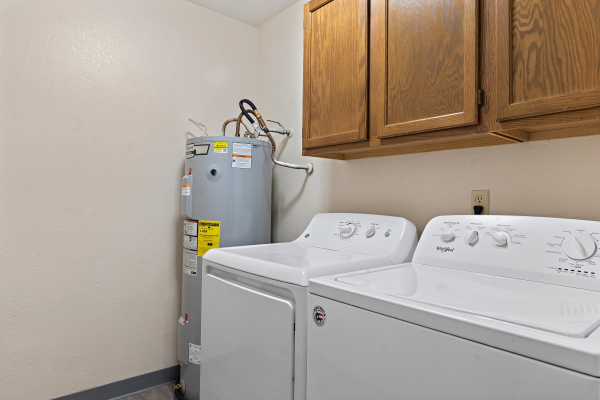 Olympic Village Apartments laundry area with cabinets - Billings, MT