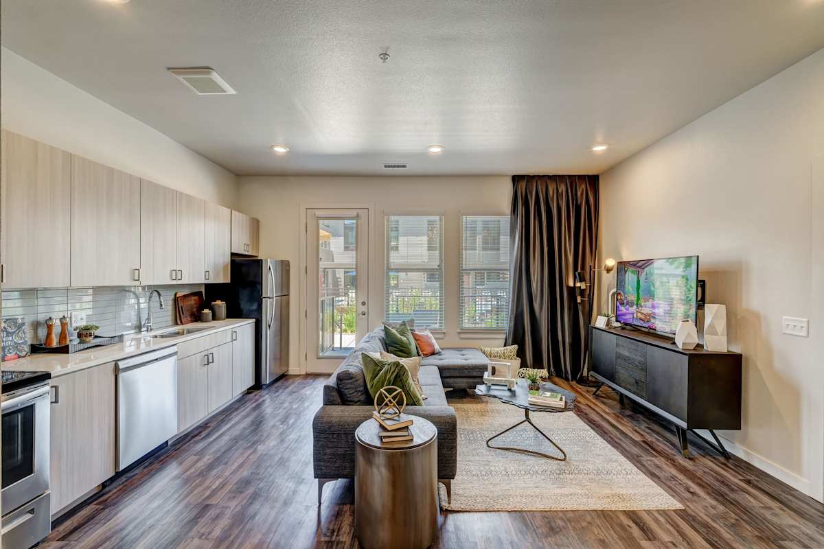 Railway Flats Apartments kitchen with stainless appliances and balcony view - Loveland, CO