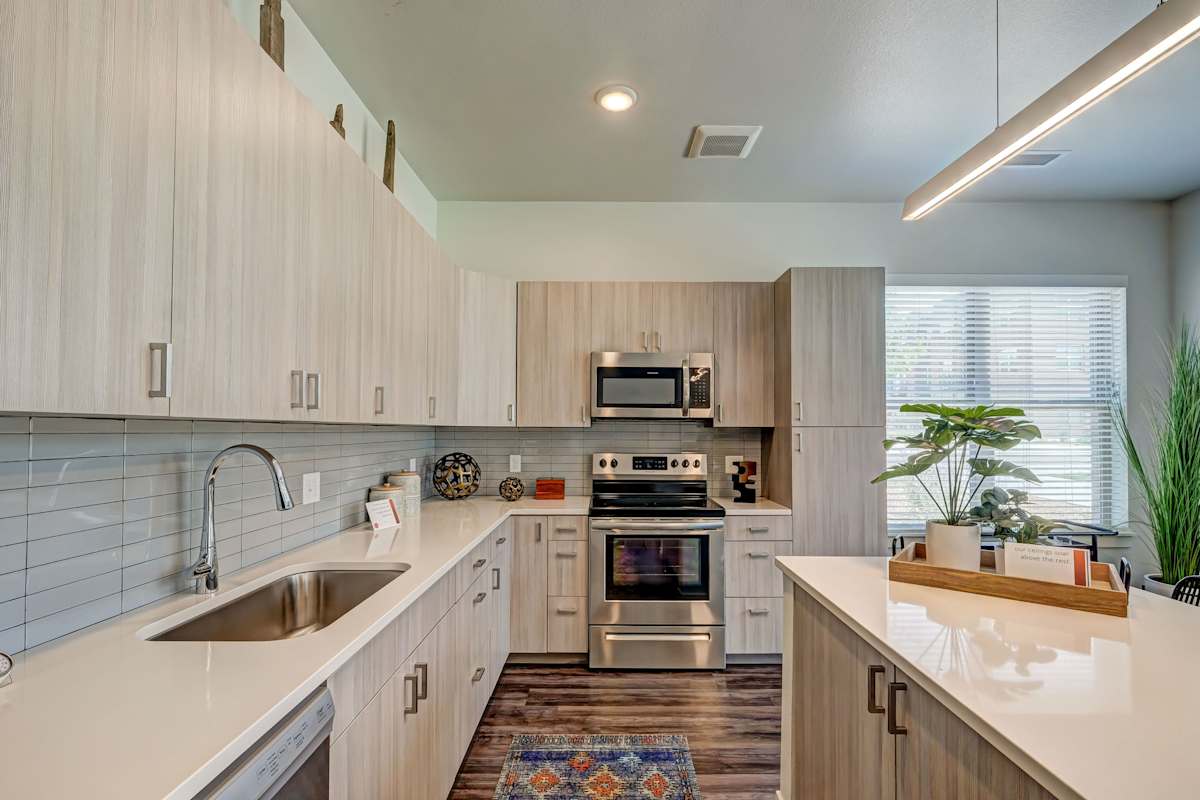 Railway Flats Apartments kitchen with white countertops and island - Loveland, CO