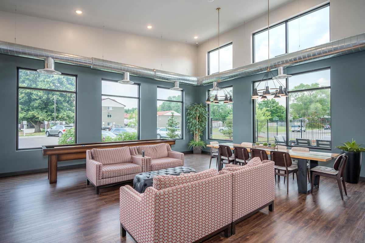 Connelly On Eleven community room with long table and seating - Burnsville, MN