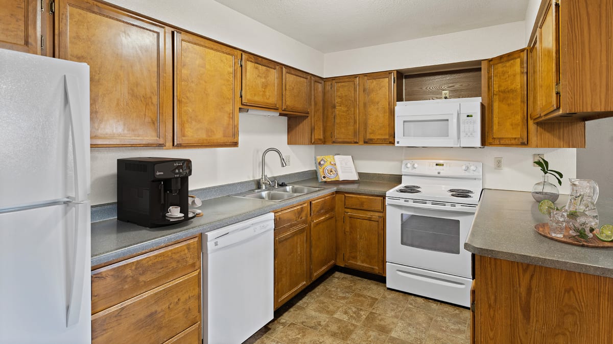 Olympic Village Apartments kitchen with cabinetry and appliances - Billings, MT