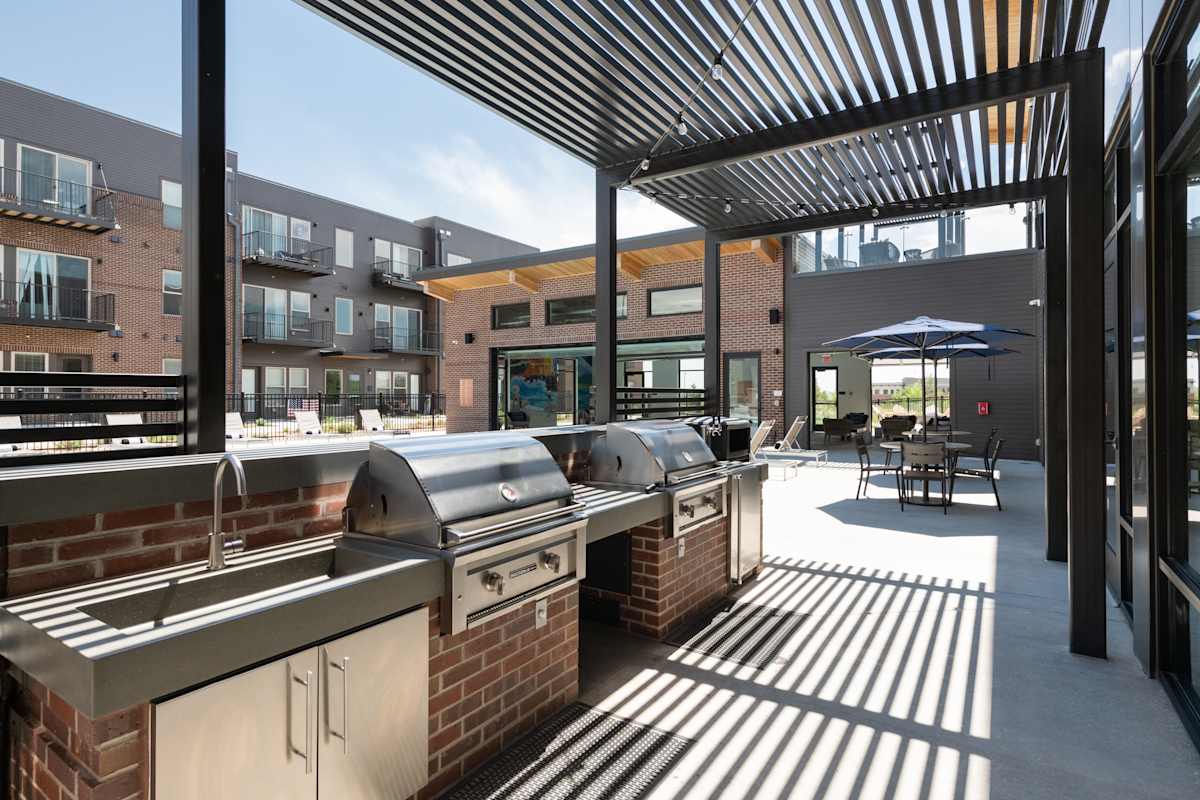 Railway Flats Apartments outdoor grilling area with seating - Loveland, CO