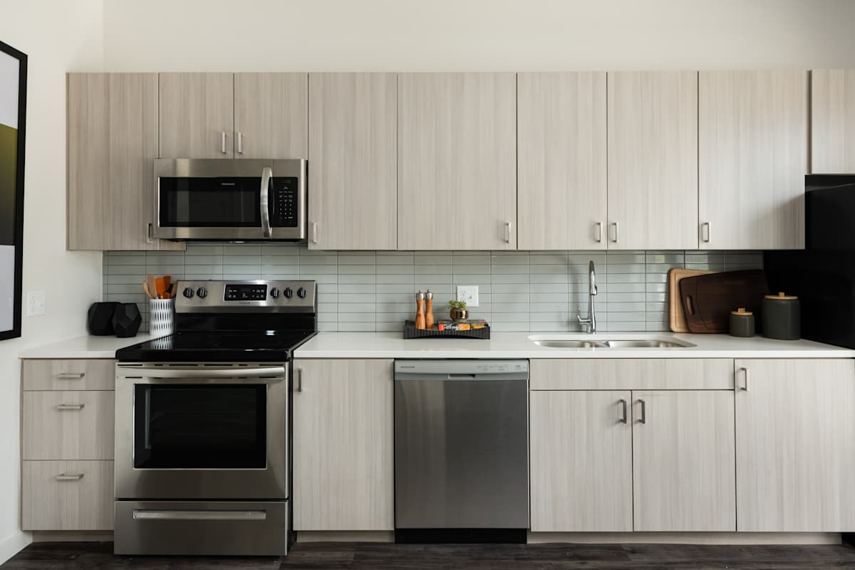 Railway Flats Apartments modern kitchen with stainless appliances - Loveland, CO