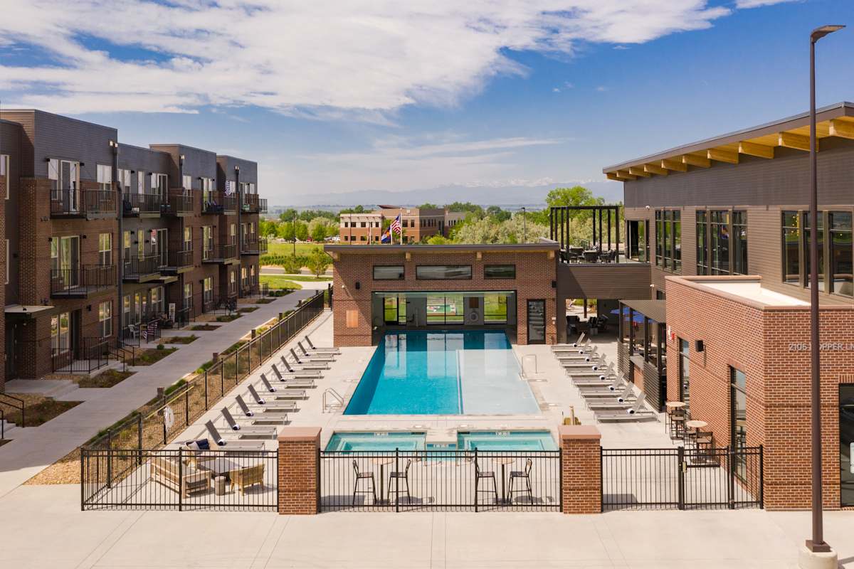 Railway Flats Apartments outdoor pool seating area - Loveland, CO