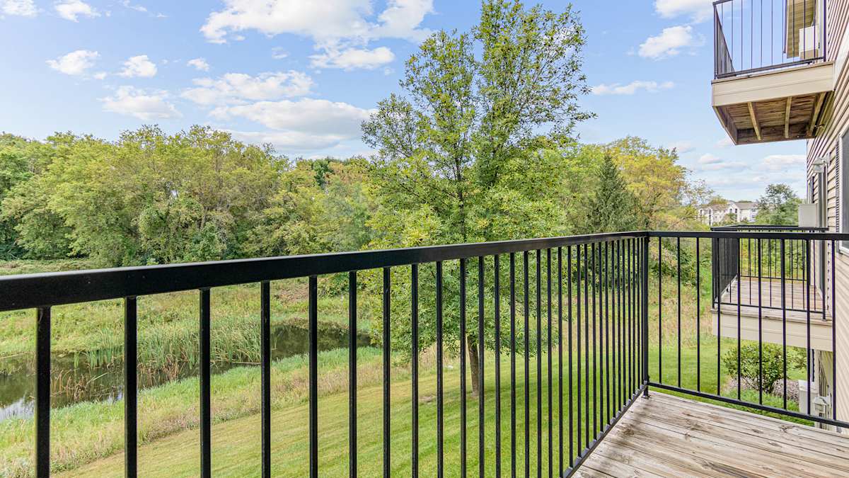 Rum River Apartments balcony with yard view - Isanti, MN