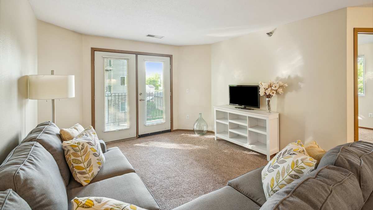 The Legacy Apartments living room with entertainment area - Grand Forks, ND