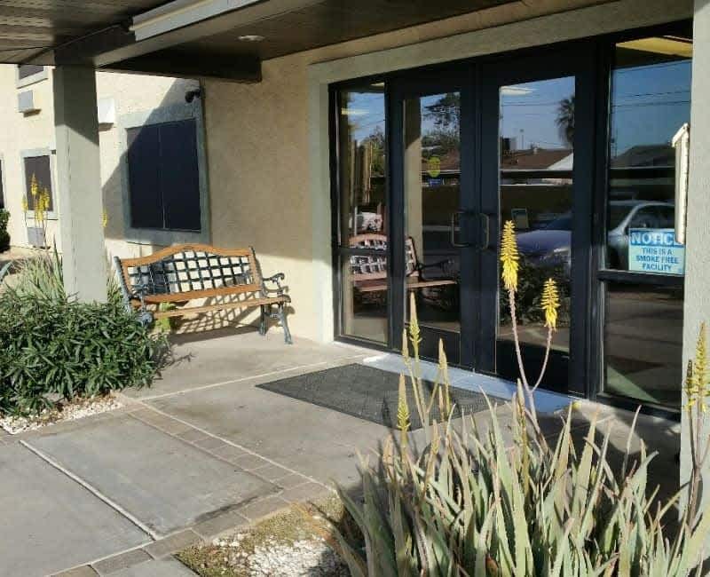 Community entrance doors and planted walkway — view 1 at Kachina Place.