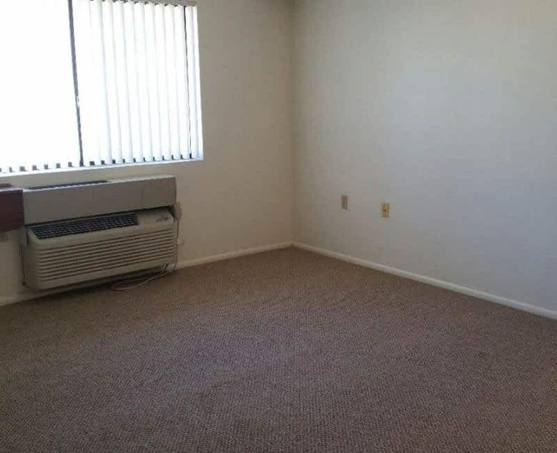 Unfurnished room with a window air conditioner — view 1 at Kachina Place.