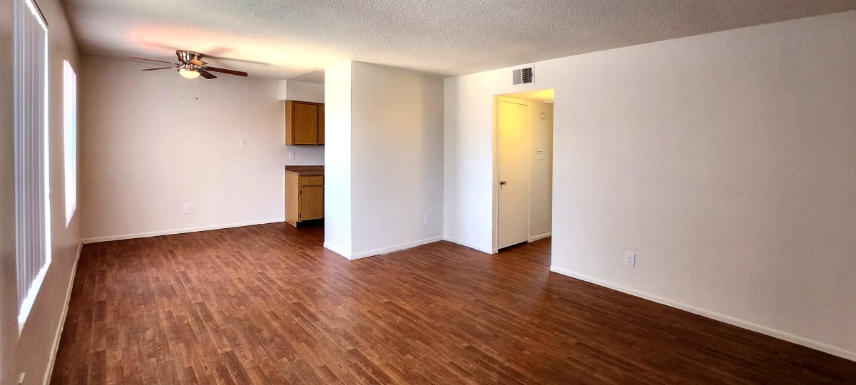 Unfurnished living space with wood-look flooring and closets — view 1 at Spinnaker Landing Apartments.