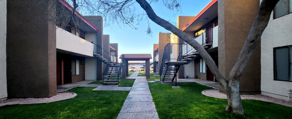 Apartment walkways beside a landscaped courtyard — view 1 at Spinnaker Landing Apartments.