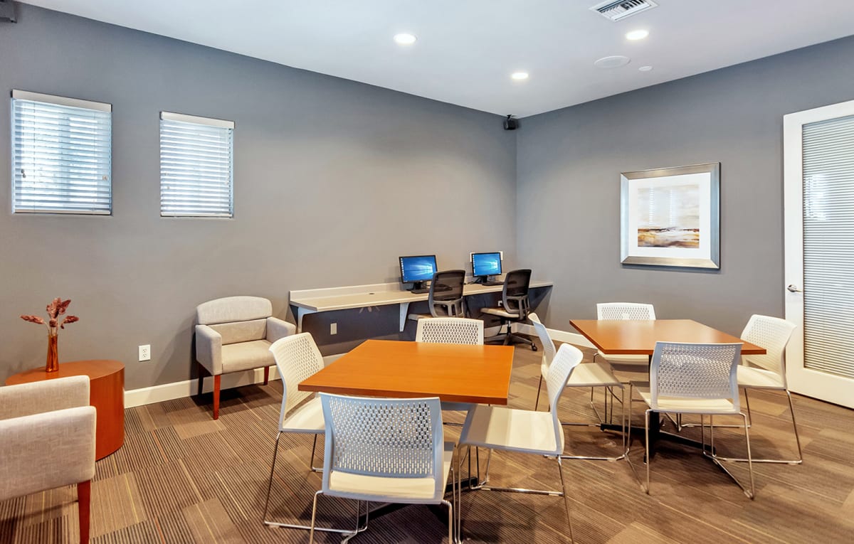 Business center with computer stations and tables.