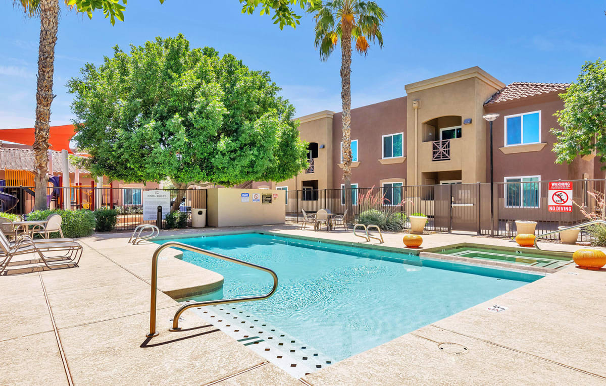 Outdoor pool with entry steps and deck seating.