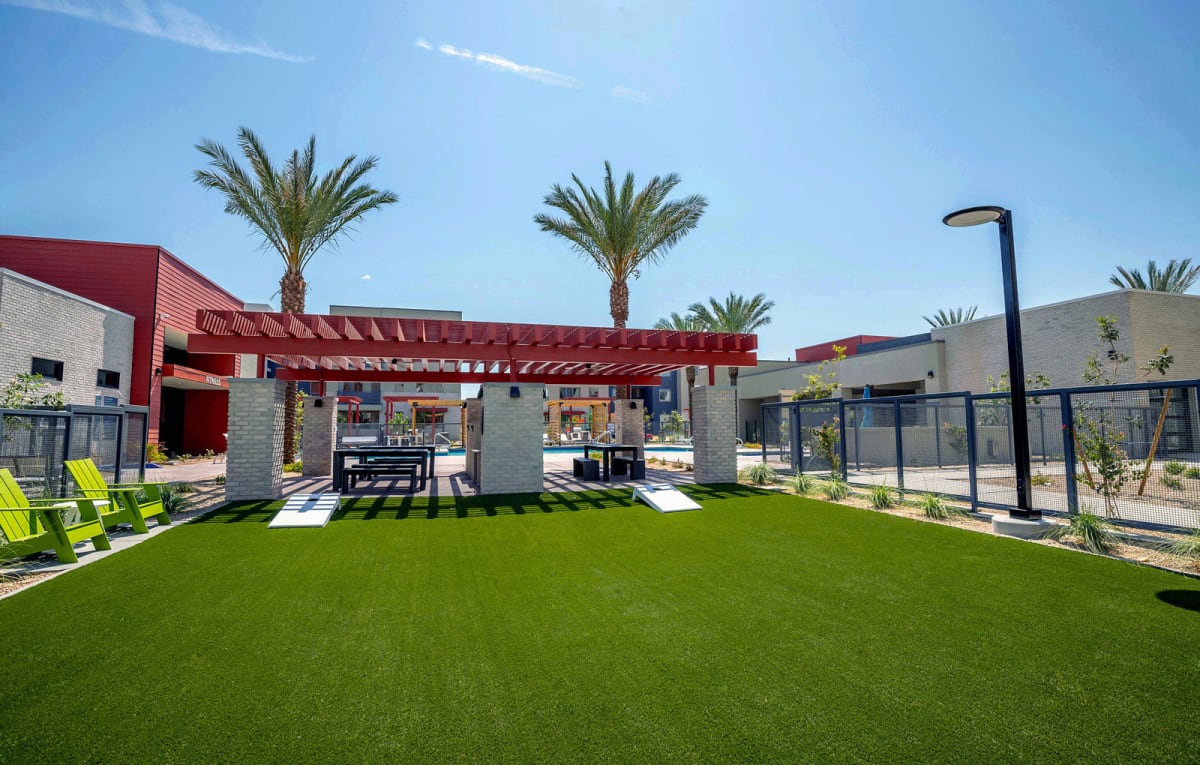 Shared lawn and shaded seating at Vista Ridge Apartments.