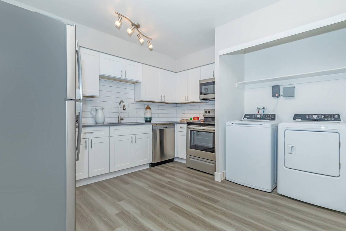 Apartment kitchen with washer and dryer at Solara.