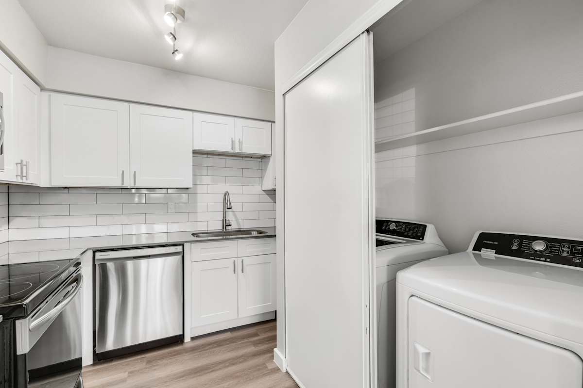 Apartment kitchen with washer and dryer at Solara.