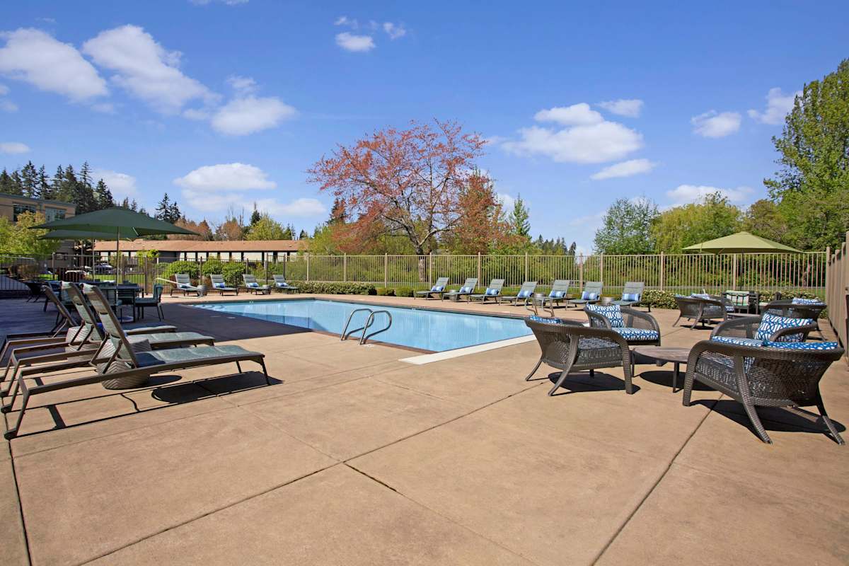 Echo Lake Apartments pool with deck seating - Shoreline, WA