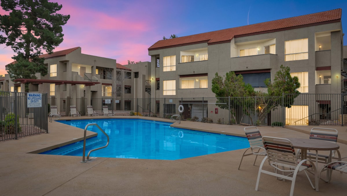 Swimming pool and surrounding deck at twilight — view 1 at Glen Brae Apartments.