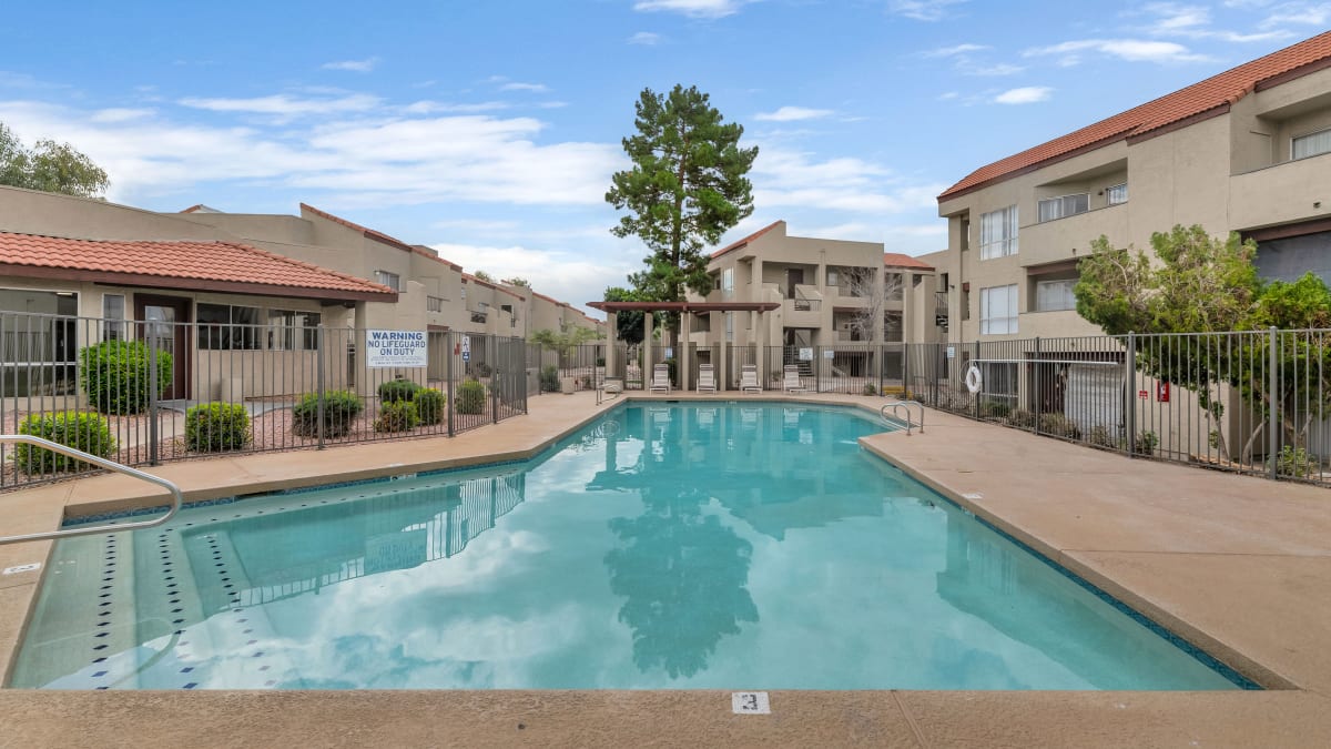 Swimming pool framed by apartment buildings — view 1 at Glen Brae Apartments.