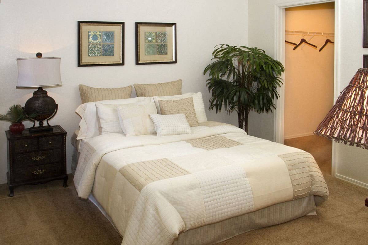Furnished bedroom shown — representative home at RidgeGate Apartments.