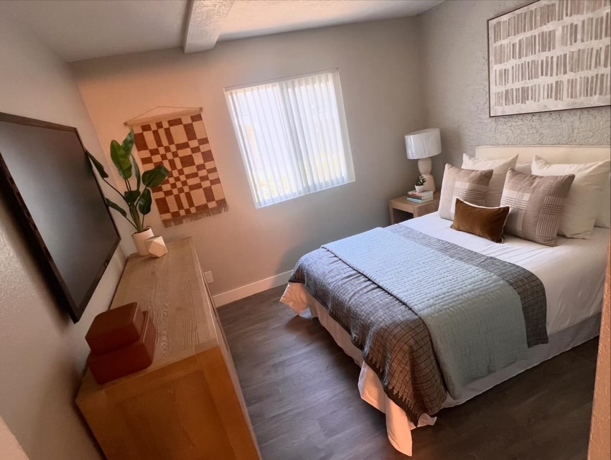 Furnished bedroom shown — representative home at North Mountain Apartments.