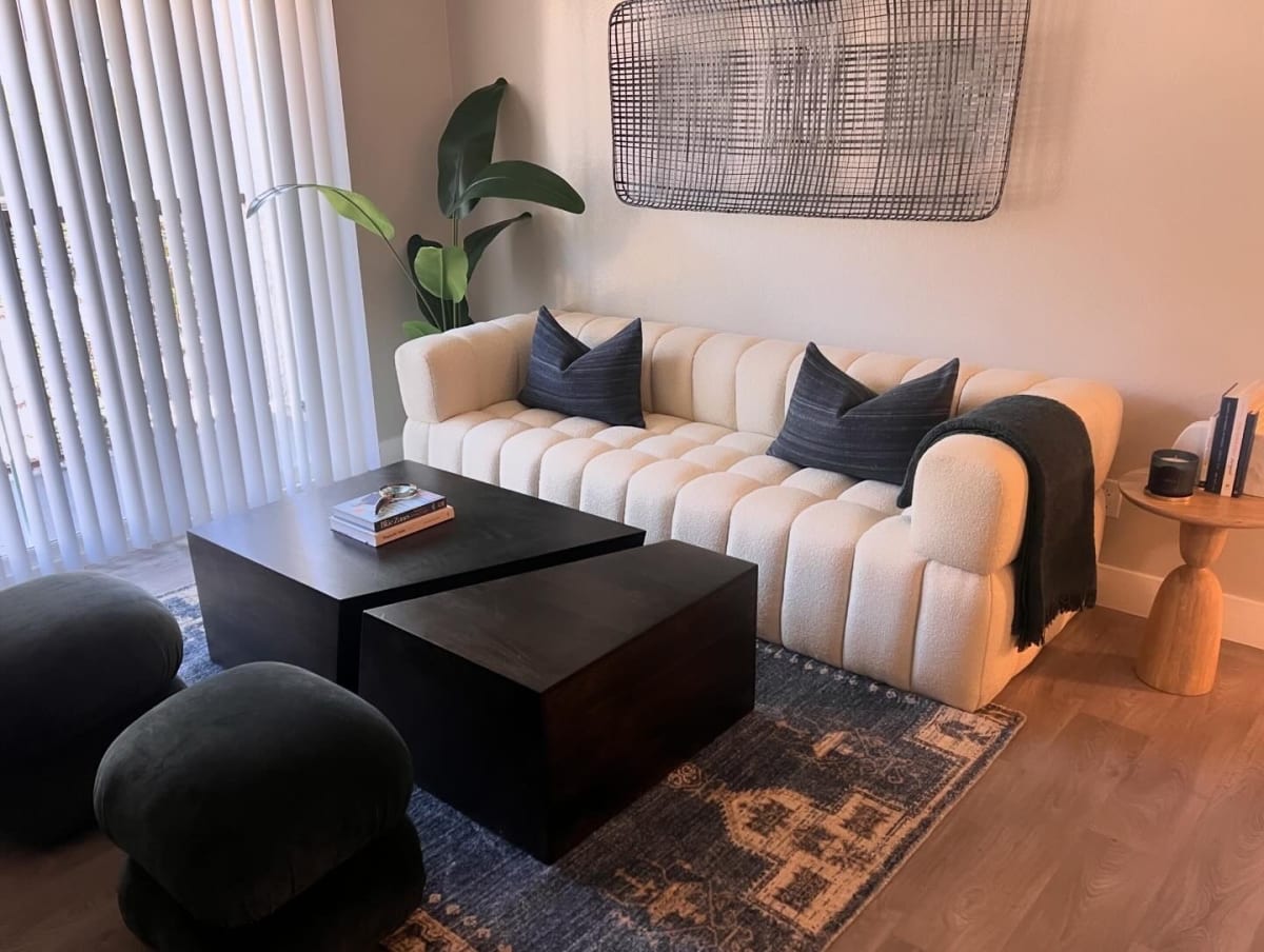 Furnished apartment living area shown — representative home at North Mountain Apartments.